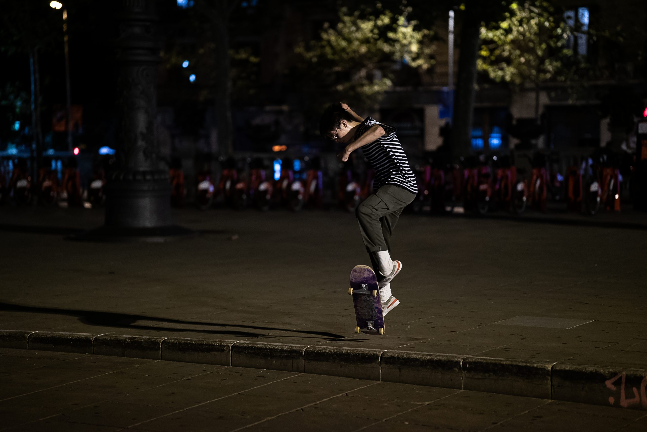 Foto de prueba de seguimiento de autofoco - skater haciendo un truco, de noche, con luz de la calle.